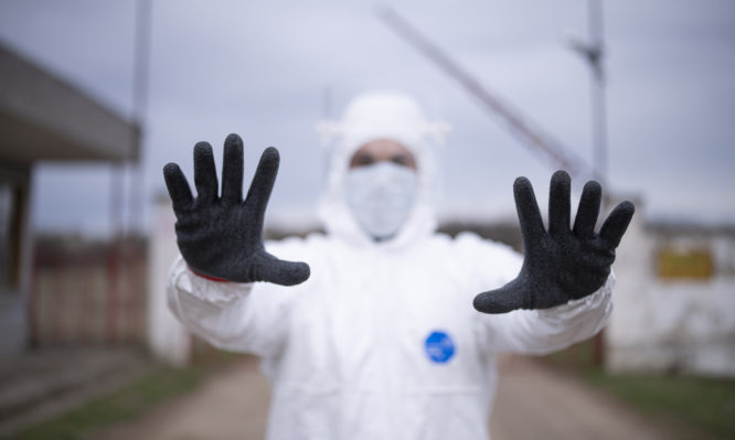 Man With Protective Suit Controlling Border Traffic,Close Border Crossing Virus Pandemic