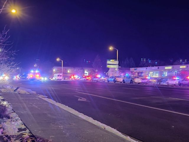 A view of various security and emergency vehicles parked on a street, after a shooting, in Colorado Springs